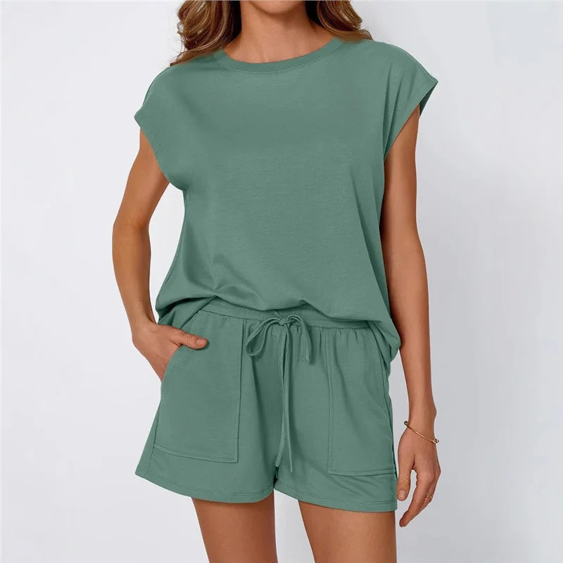 Green outfit with top and shorts on a plain background