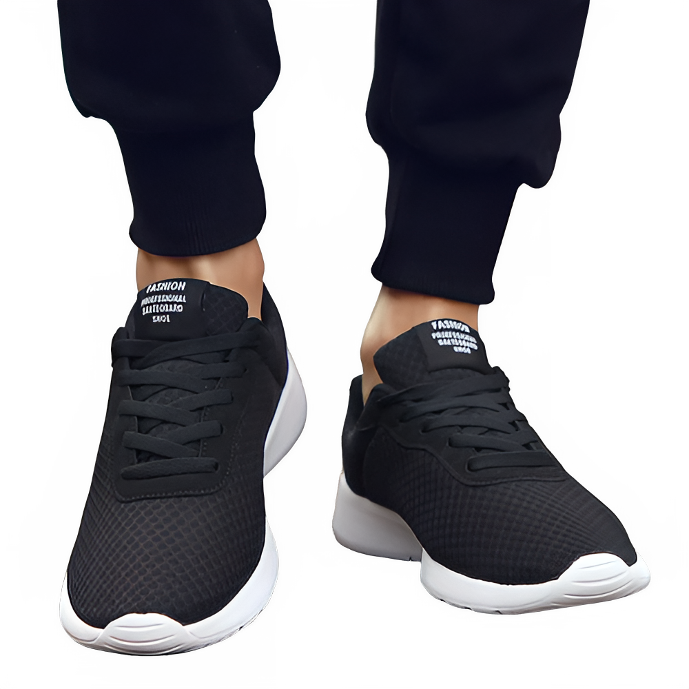 Men's Malcom Sneaker in black with breathable mesh upper and lightweight white sole for everyday comfort.