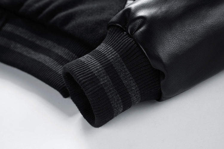 Close-up of a black leather jacket on a light gray background