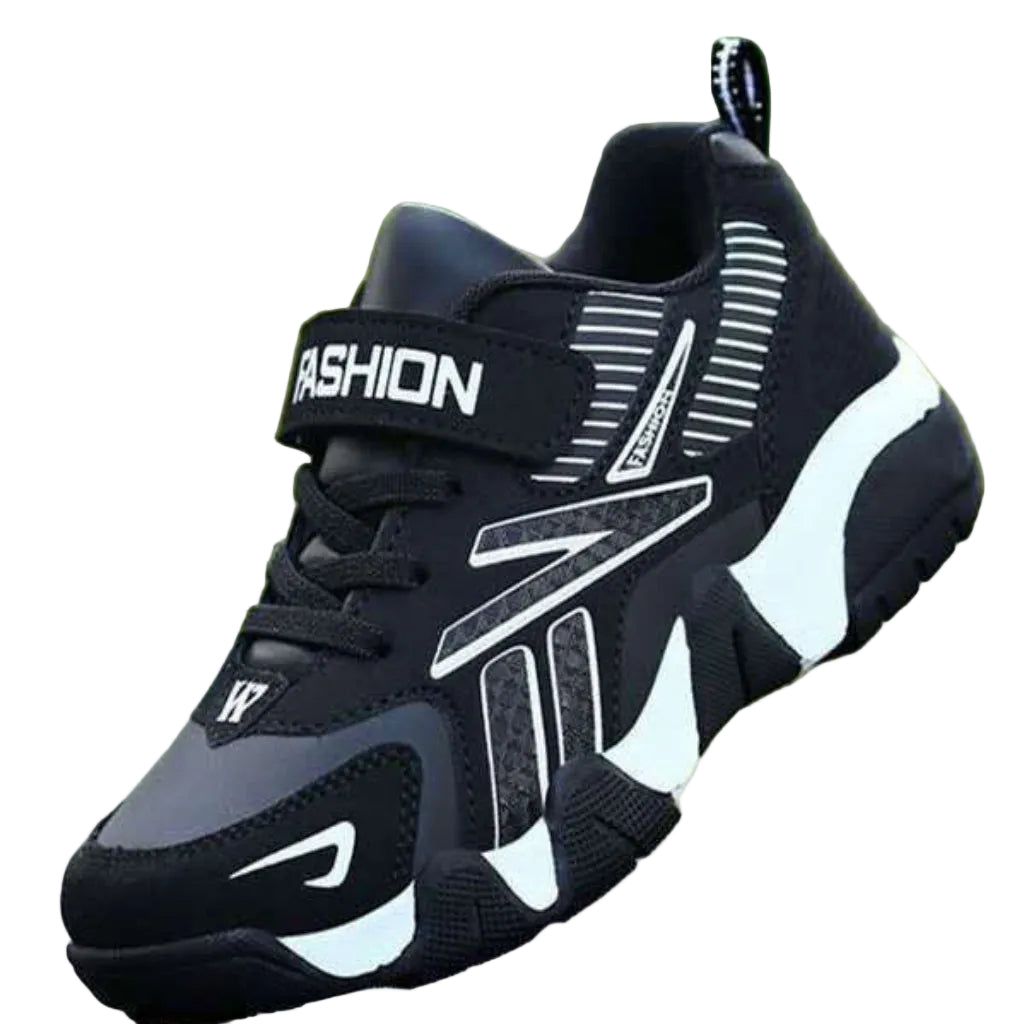 A pair of kids' sport sneakers with a black and white design, featuring a lace-up closure and the word 'FASHION' printed on the side.