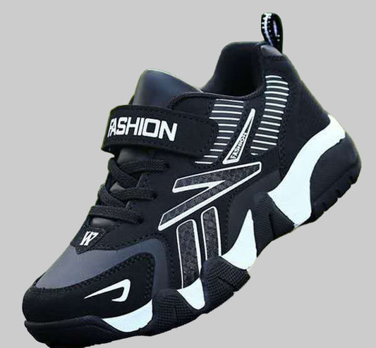 A pair of kids' sport sneakers with a black and white design, featuring a lace-up closure and the word 'FASHION' printed on the side.