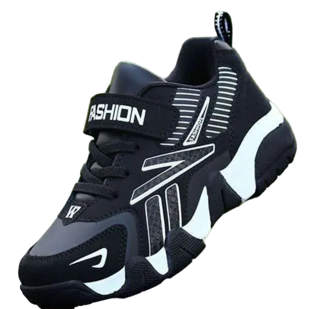 A pair of kids' sport sneakers with a black and white design, featuring a lace-up closure and the word 'FASHION' printed on the side.