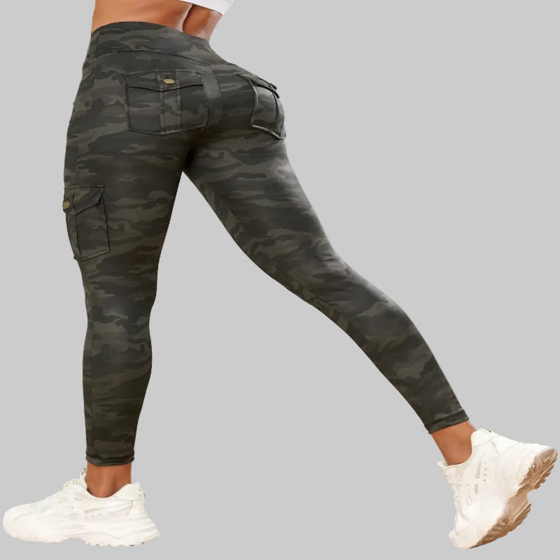 Camouflage pants worn by a person indoors with a neutral background