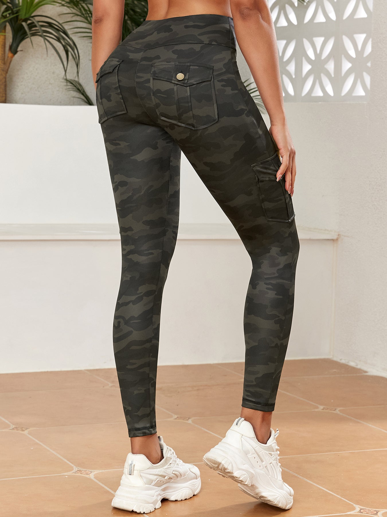 Camouflage pants worn by a person on a neutral background