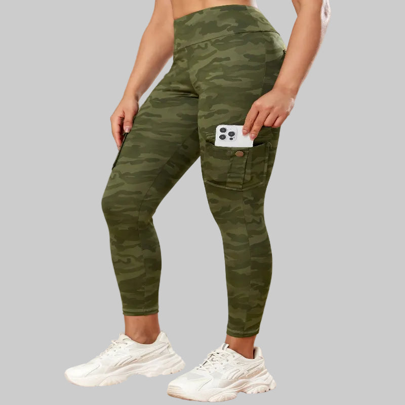 Person wearing green camouflage leggings with a white background