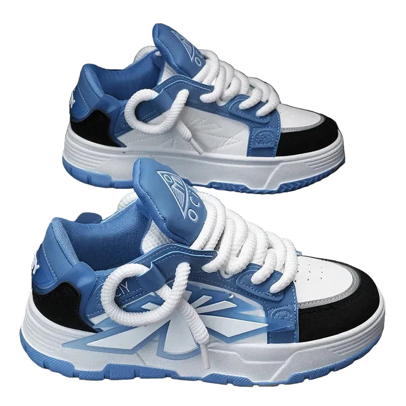 Blue and white sneakers with black accents on a gray surface