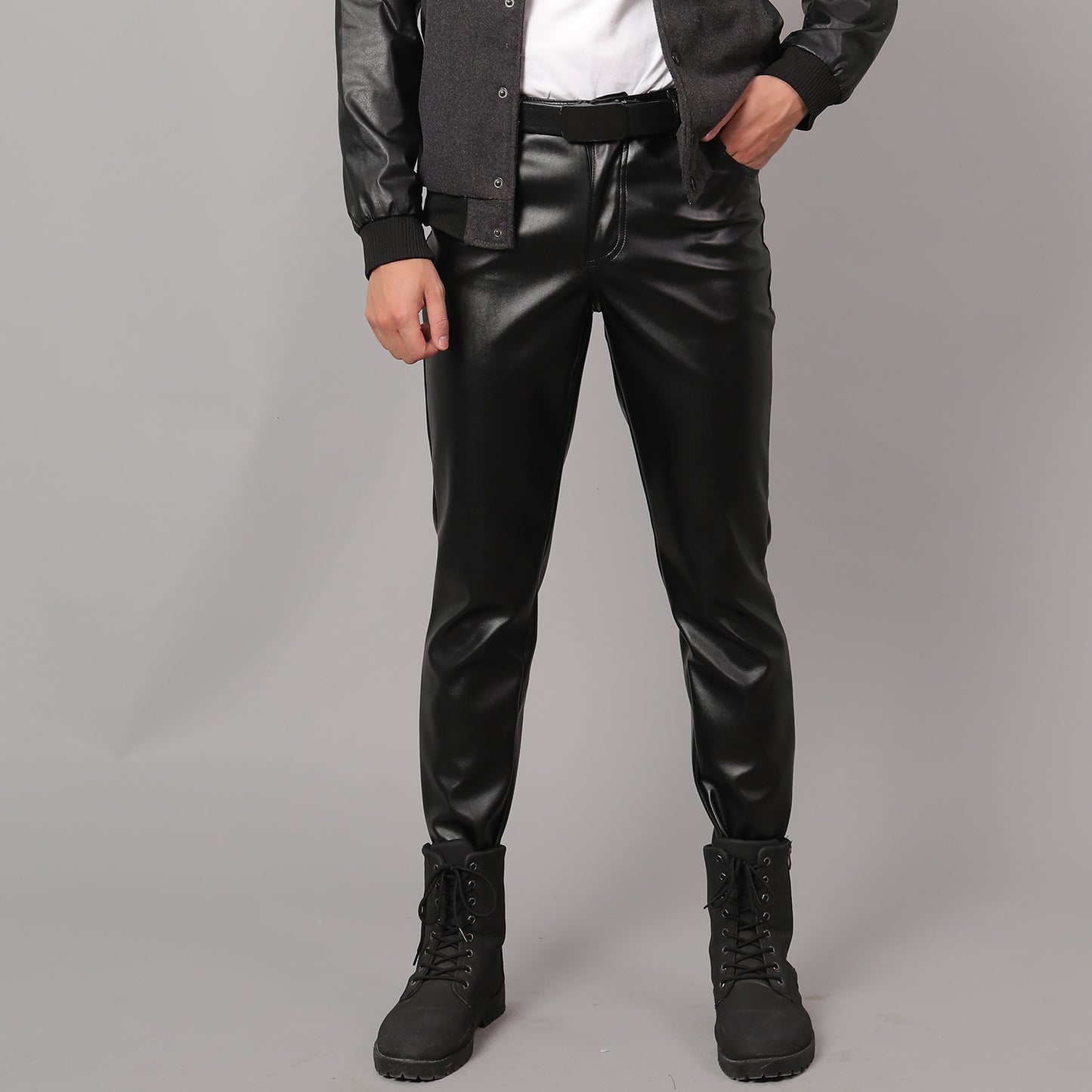 Person wearing Black Leather Pants for Men and black boots on a gray background