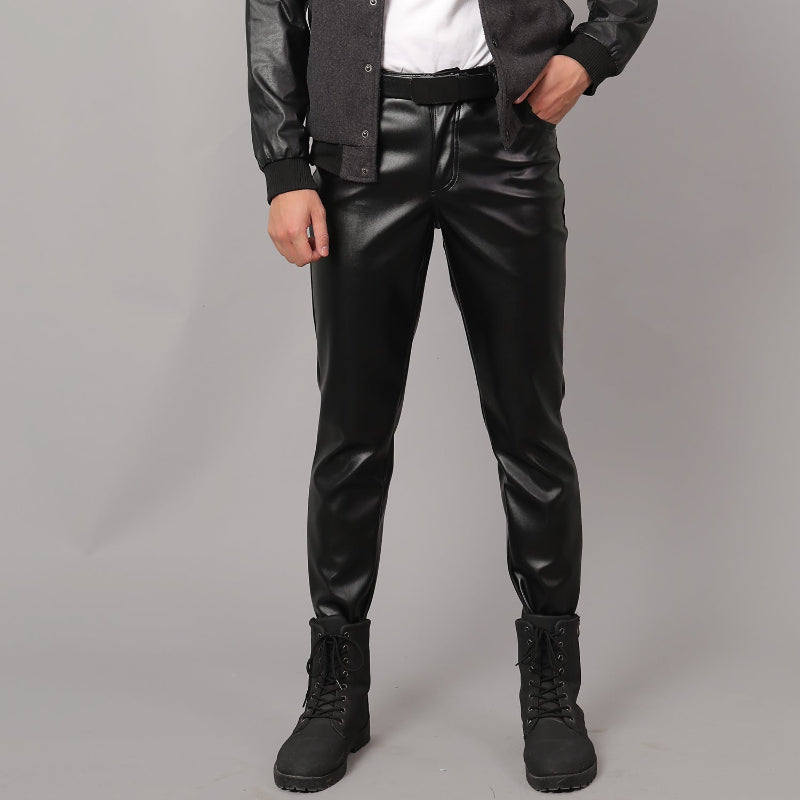 Person wearing Black Leather Pants for Men and black boots on a gray background