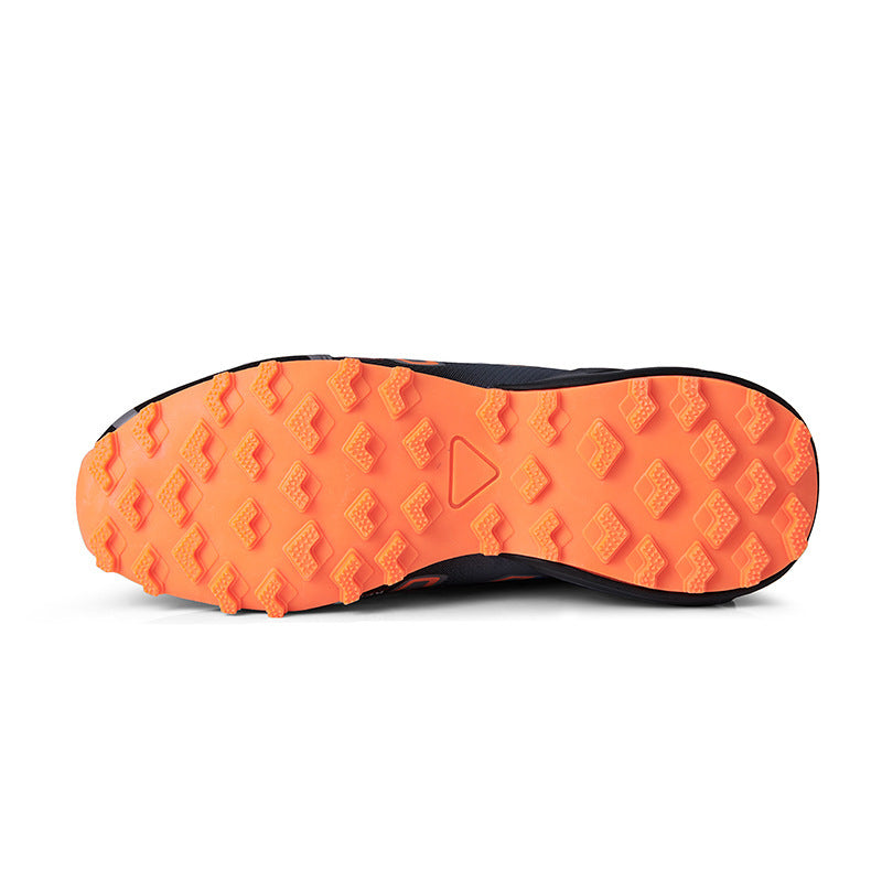 Close-up of a shoe sole with orange tread pattern on a white background