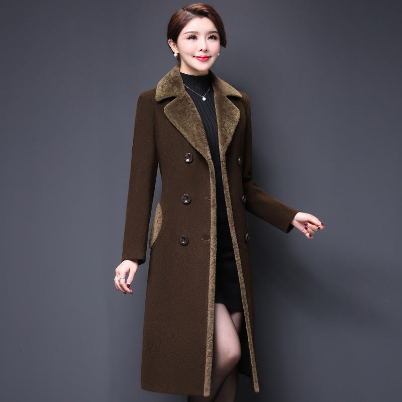 Woman wearing a brown coat with a gray background