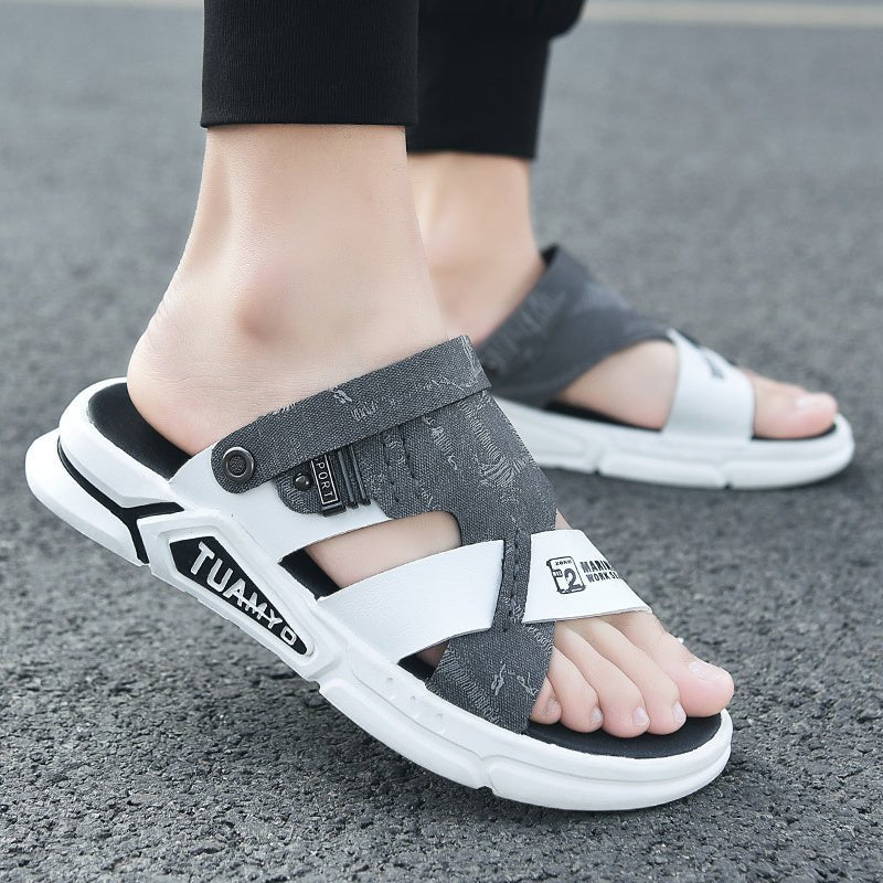 Gray and white sandals with brand logo on a gray surface