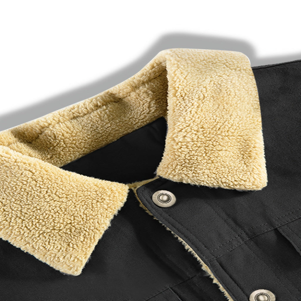 Close-up of a black jacket with beige sherpa lining on a white background