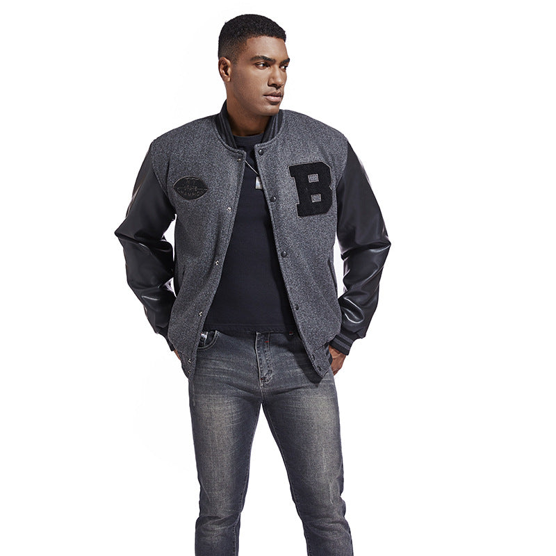 Man wearing a gray varsity jacket with a letter 'B' patch on a white background