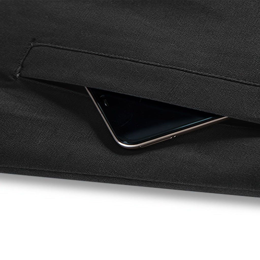 Black clutch bag with a phone inside on a white background