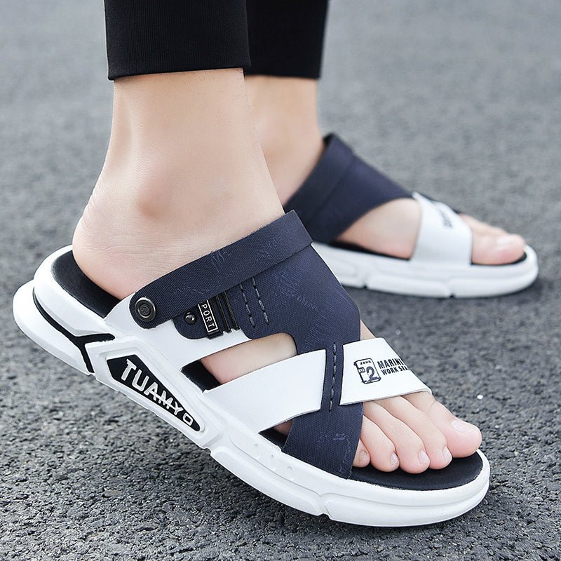 Navy and white sandals with brand logo on a gray surface