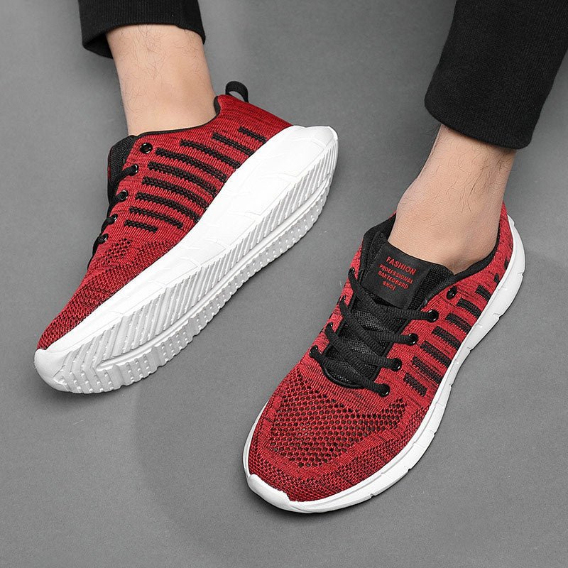Red and black sneakers with white soles on a gray background