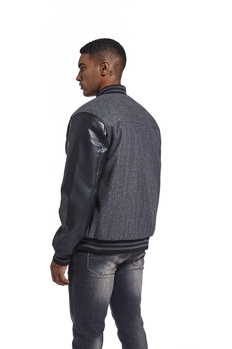 Man wearing a gray jacket with leather sleeves on a white background
