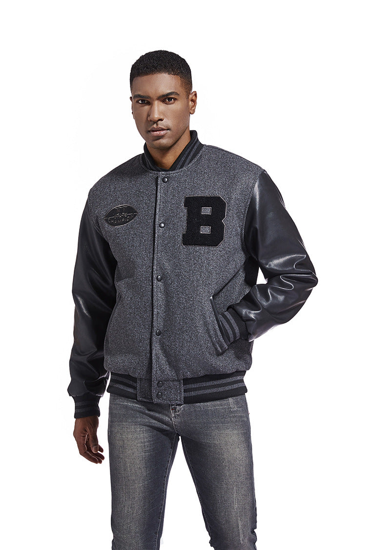 Man wearing a gray varsity jacket with black lettering on a white background
