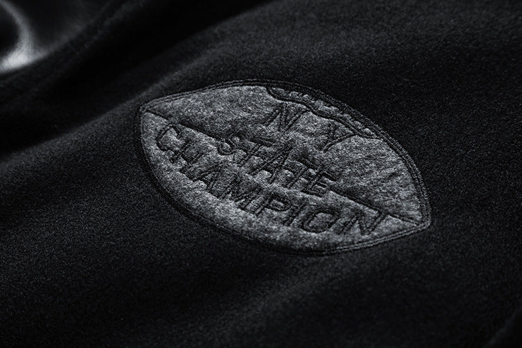 Embossed 'State Champion' badge on a dark fabric surface