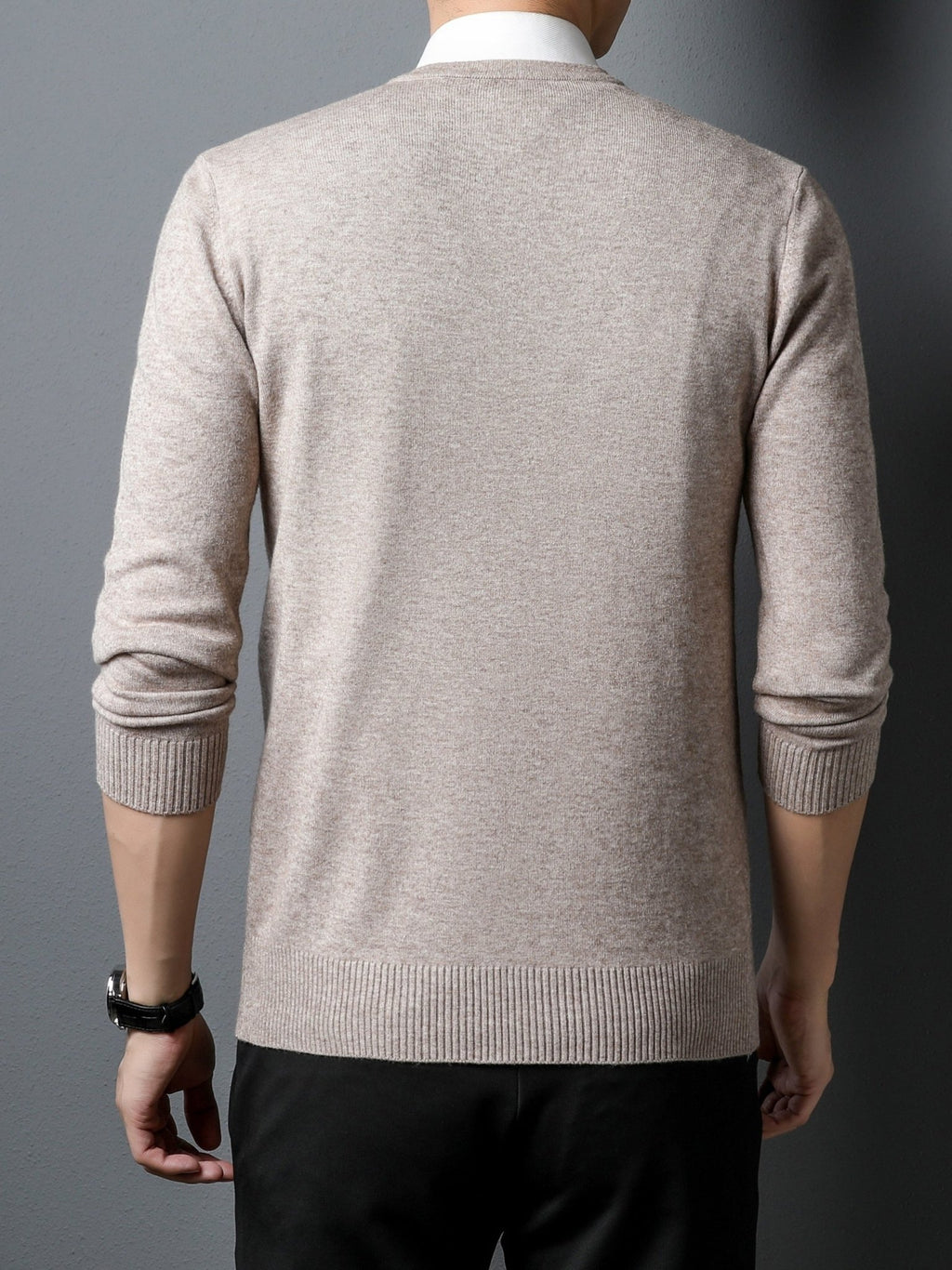Man wearing a beige Men's Knitted V-neck Sweater  on a gray background