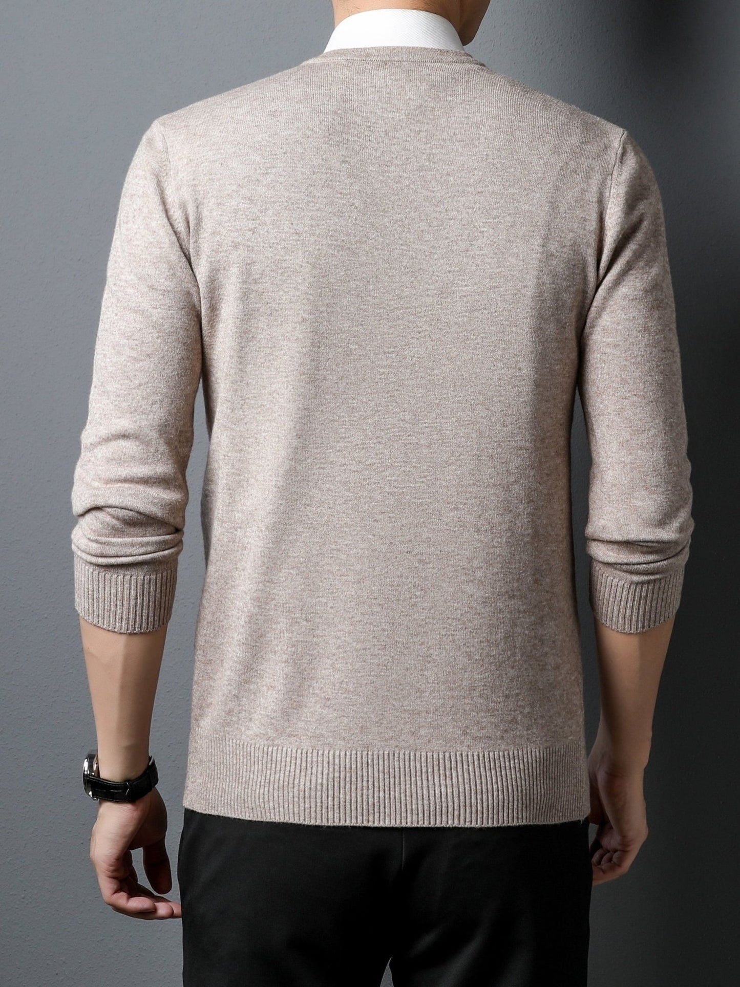 Man wearing a beige Men's Knitted V-neck Sweater  on a gray background