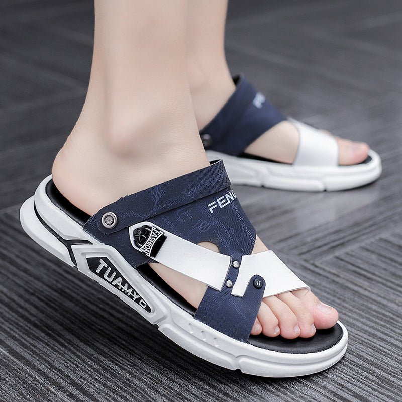 Navy and white sandals worn on a gray floor