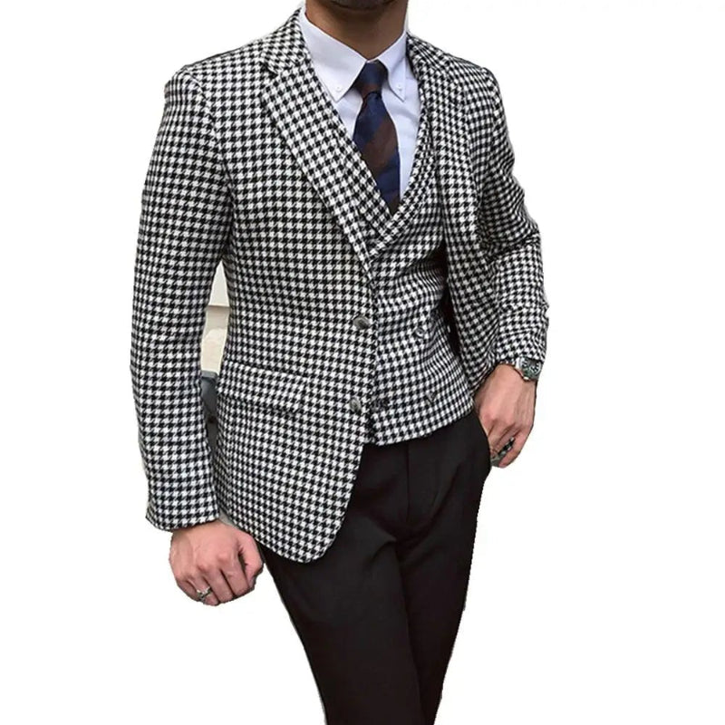 Person wearing a black and white checkered blazer with a white shirt and dark tie on a white background