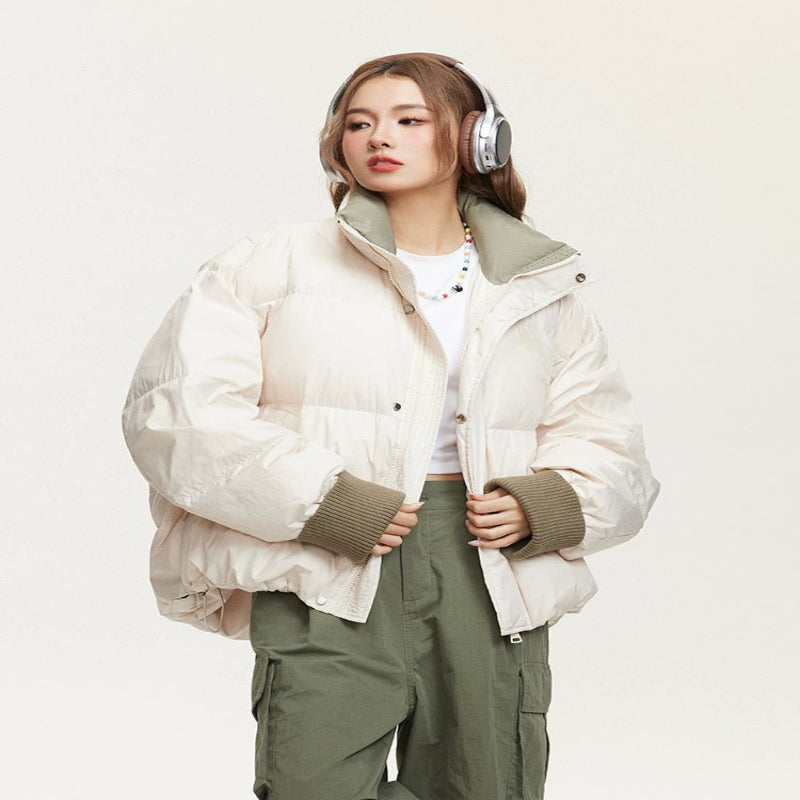 Woman wearing a lightweight puffer jacket in a slim, stylish fit for cold weather.