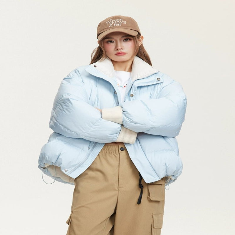 Woman wearing a lightweight puffer jacket in a slim, stylish fit for cold weather.