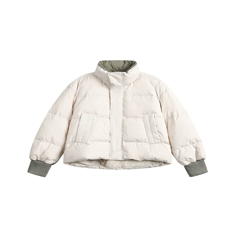 Woman wearing a lightweight puffer jacket in a slim, stylish fit for cold weather.