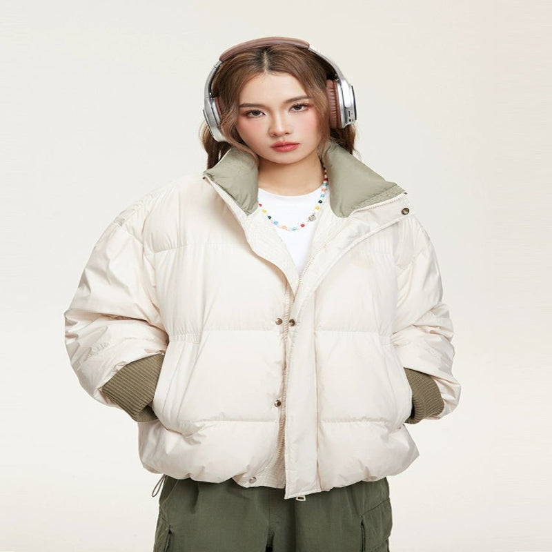 Woman wearing a lightweight puffer jacket in a slim, stylish fit for cold weather.