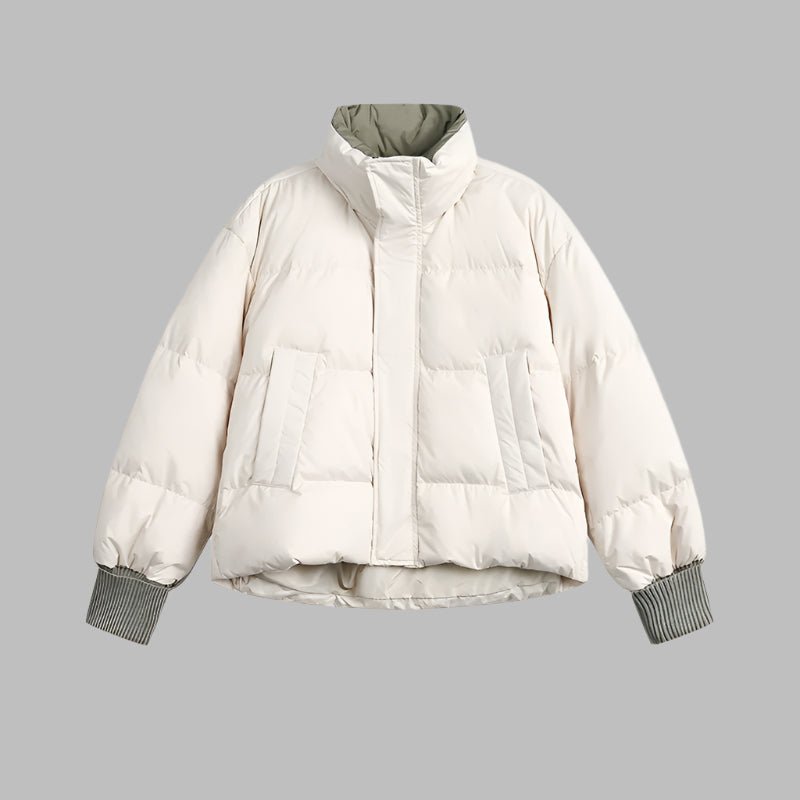 Woman wearing a lightweight puffer jacket in a slim, stylish fit for cold weather.