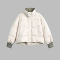 Woman wearing a lightweight puffer jacket in a slim, stylish fit for cold weather.