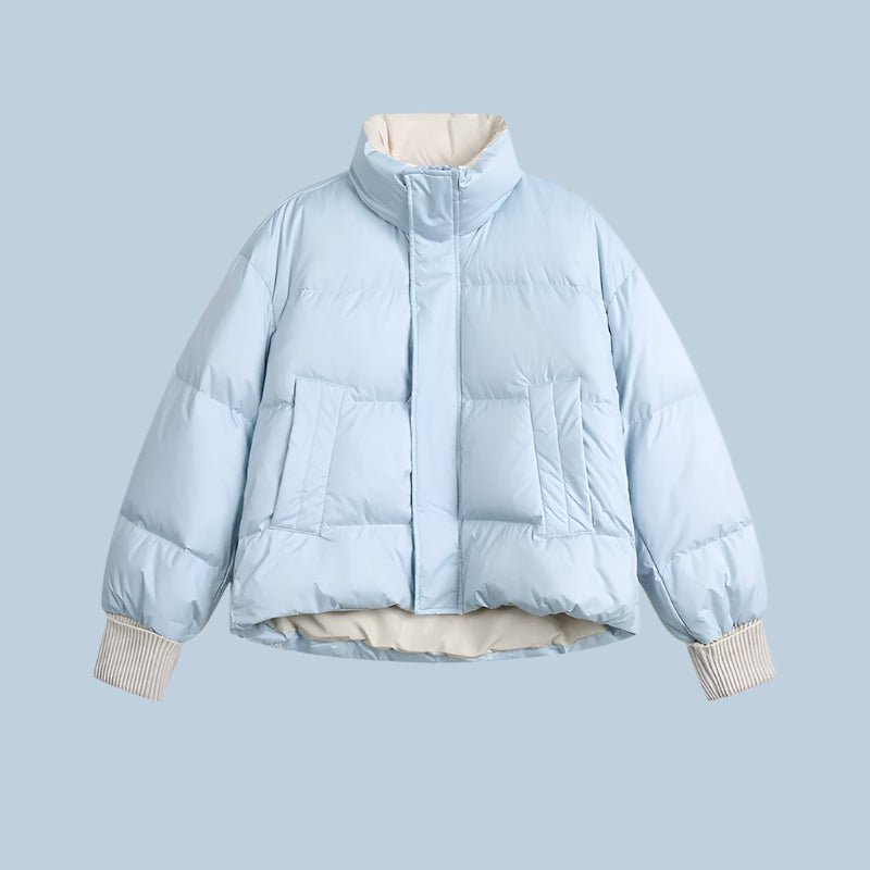 Woman wearing a lightweight puffer jacket in a slim, stylish fit for cold weather.
