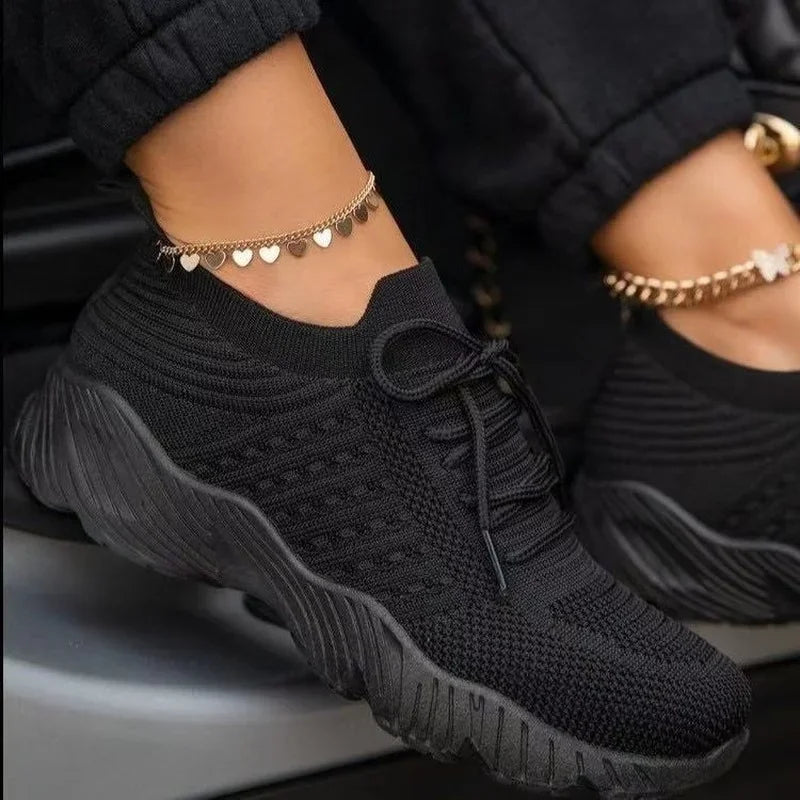 Women's Black mesh sneakers with matching laces and textured soles at Casual Flow Shop