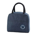 Blue insulated lunch bag with black handles on a white background