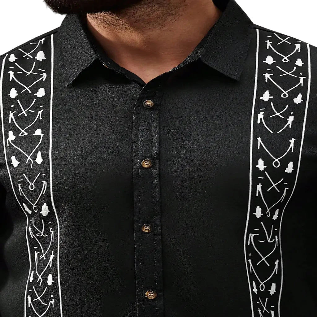Black guayabera shirt with white embroidered designs on a neutral background