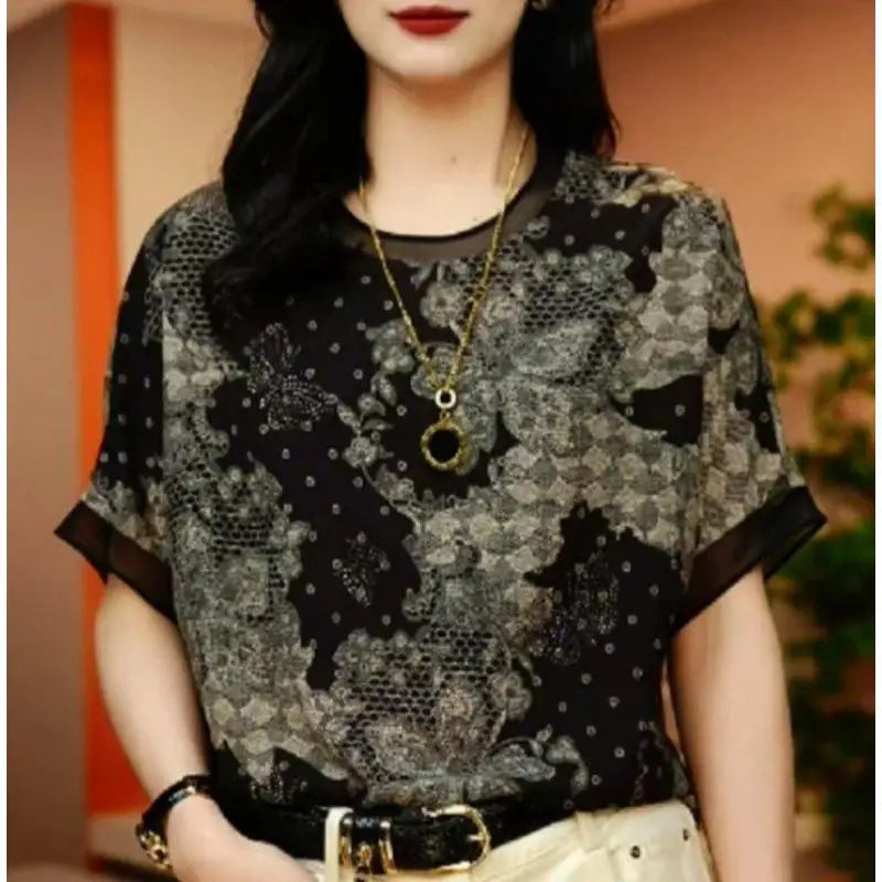 Person wearing a patterned top with a blurred background