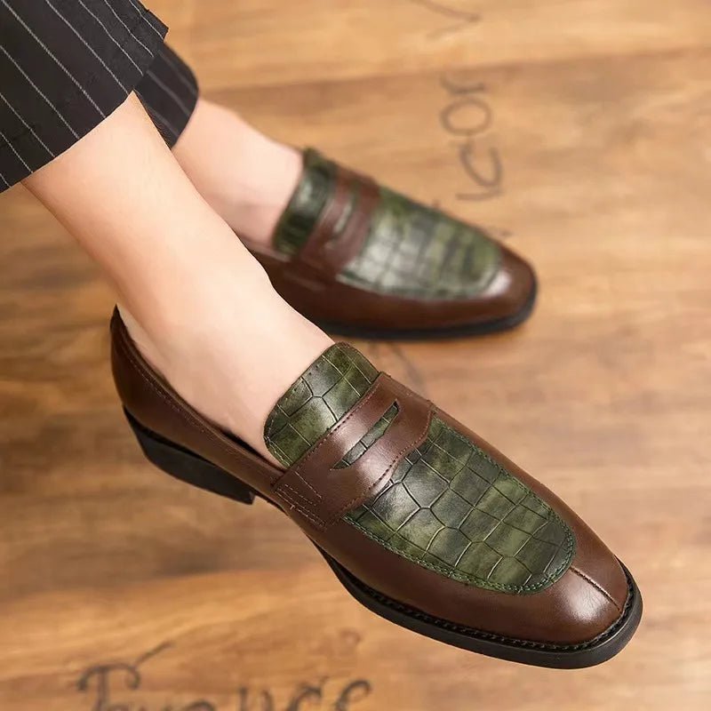 Brown and green loafers on a wooden floor