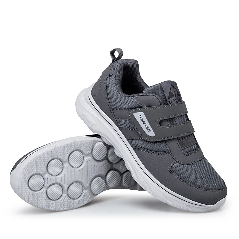 Gray children's sneakers with white soles on a white background