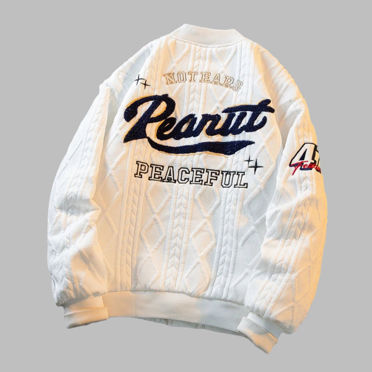 White cable-knit varsity jacket for kids – soft, warm, and stylish outerwear with ribbed cuffs and embroidered patches