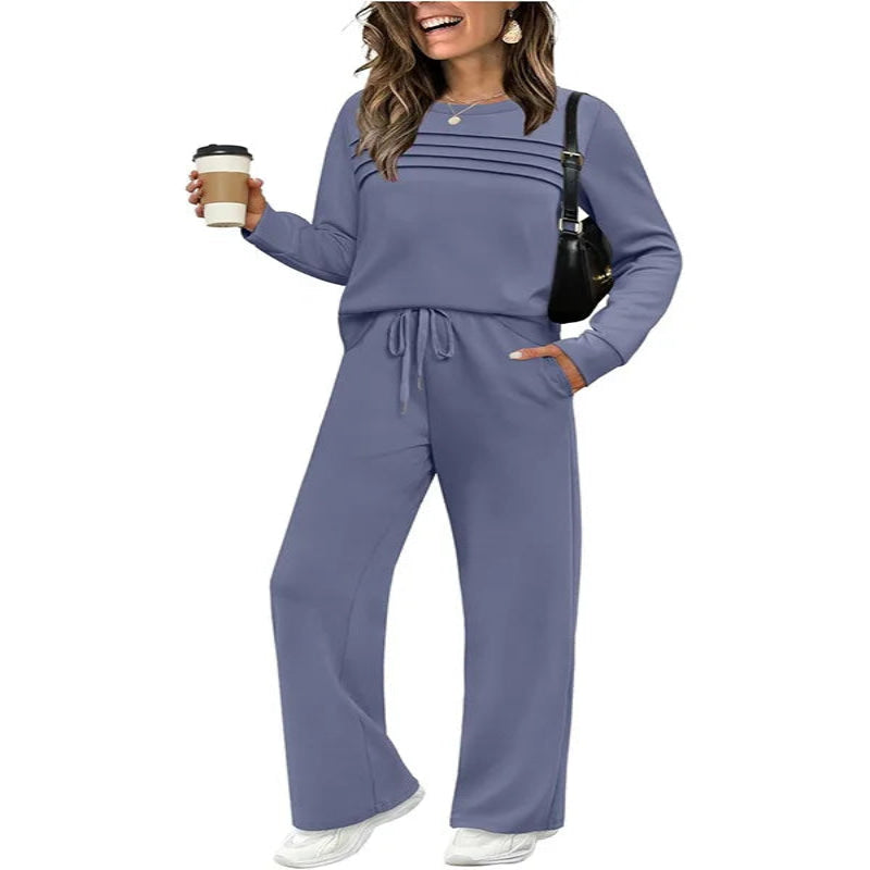 Woman wearing a blue tracksuit holding a coffee cup on a white background