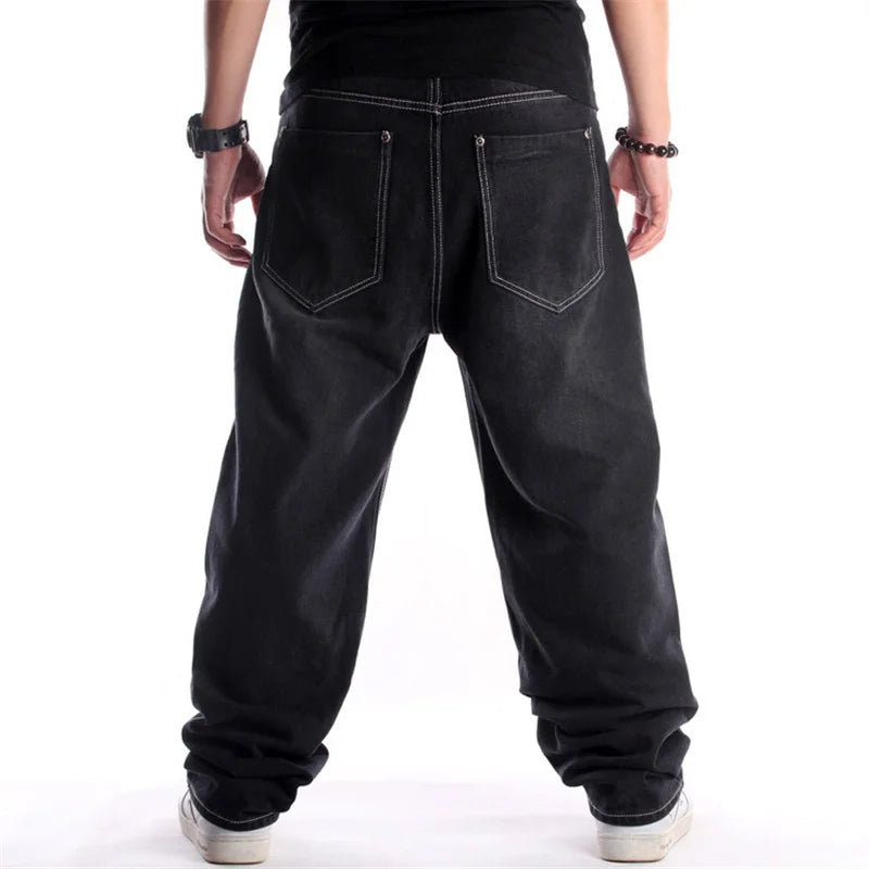 Black baggy jeans worn by a person on a white background