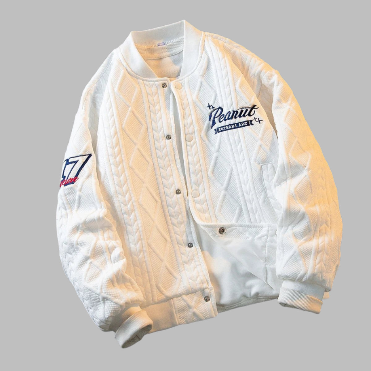 White cable-knit varsity jacket for kids – soft, warm, and stylish outerwear with ribbed cuffs and embroidered patches