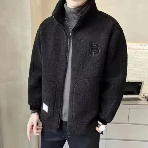 Person wearing a black fleece jacket with a brand logo indoors.