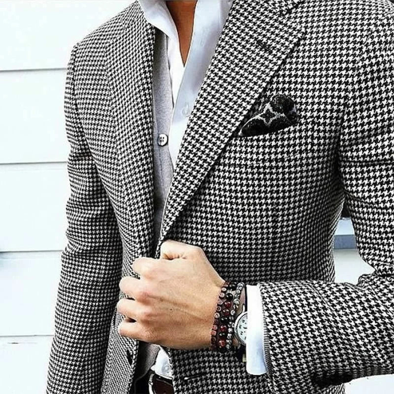 Houndstooth pattern blazer worn by a person with a white shirt and black pocket square.