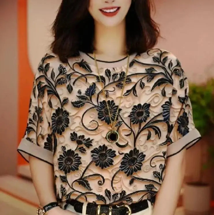 Woman wearing a black floral lace top with a blurred background
