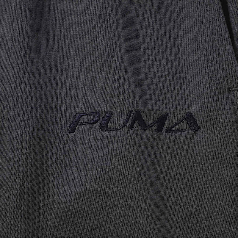 Close-up of dark gray Men's lightweight knit jogger pants with tonal black embroidered logo on the chest.
