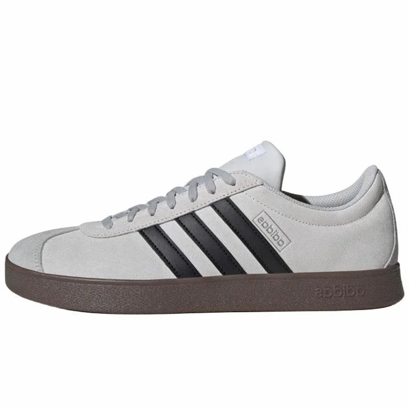 White Retro Low Top Sneakers with black stripes branding on a white background