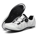 White cycling shoes with black soles on a white background